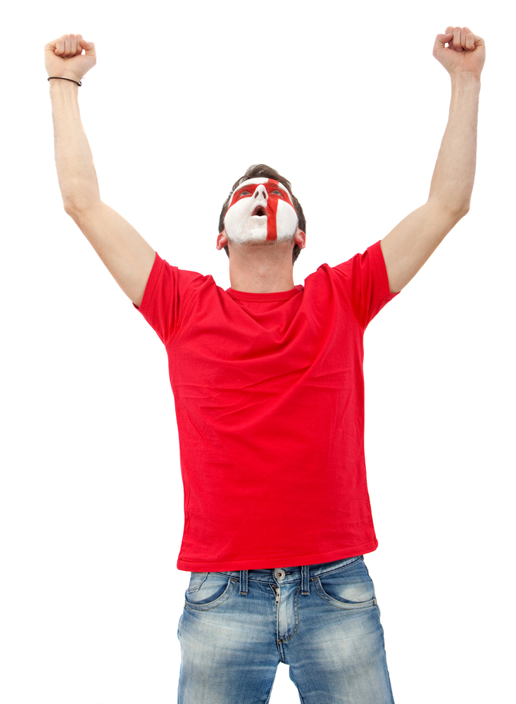 Portrait of a man with the english flag painted on his face isolated over white